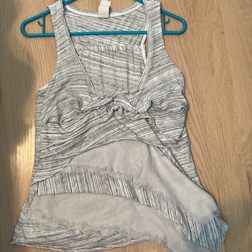 Grey top with rough looking texture.